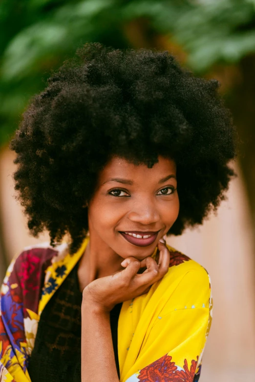 a beautiful woman smiling with a large afro