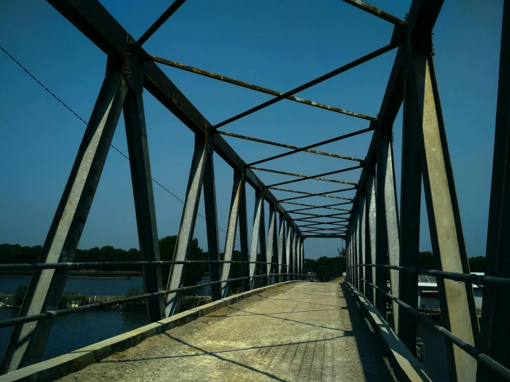 the inside of a bridge that is next to water