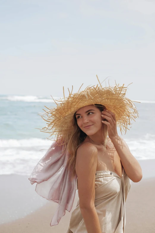  wearing a straw hat by the sea on beach