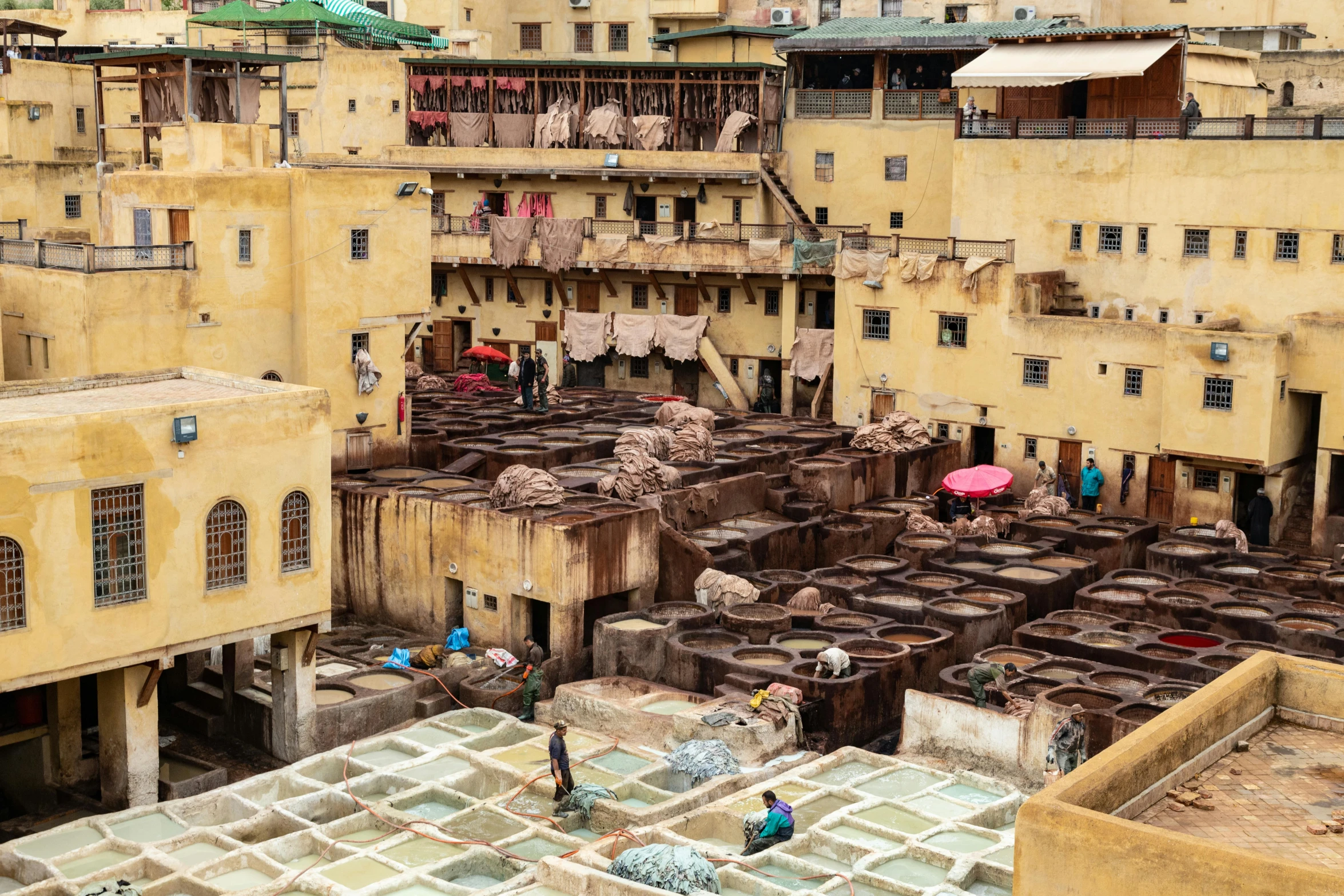 an overhead view of two buildings with people and laundry drying