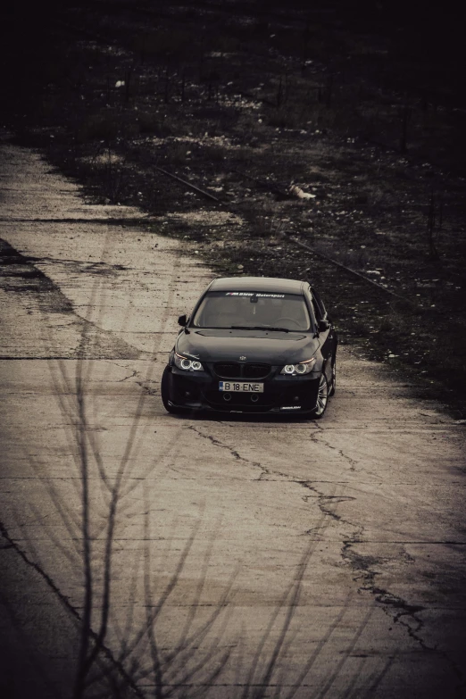 a car driving down a road on a wet surface