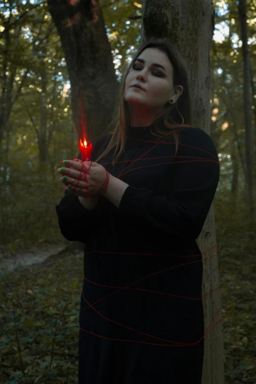 a woman holding a lighted candle in her hands