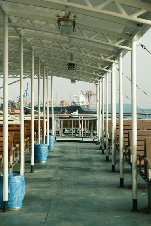 there are benches under a covered pavilion on the beach