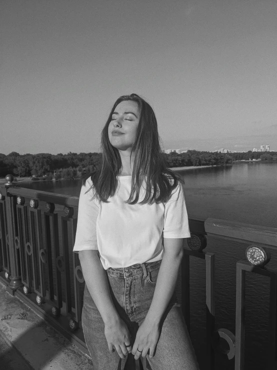 a woman sitting on a bench looking up at the sky