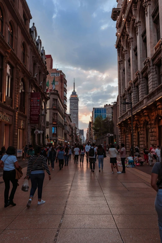 people walk down the street in the center of the city