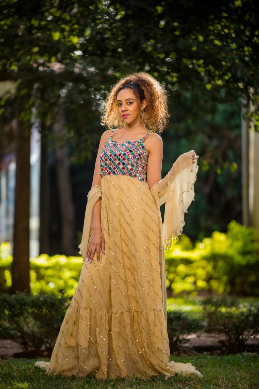 an indian woman posing in a gown