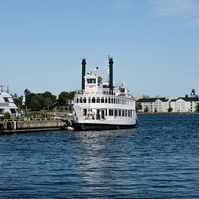 a ferry that is docked next to a city