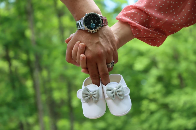 a woman holding the hand of a man holding his hand