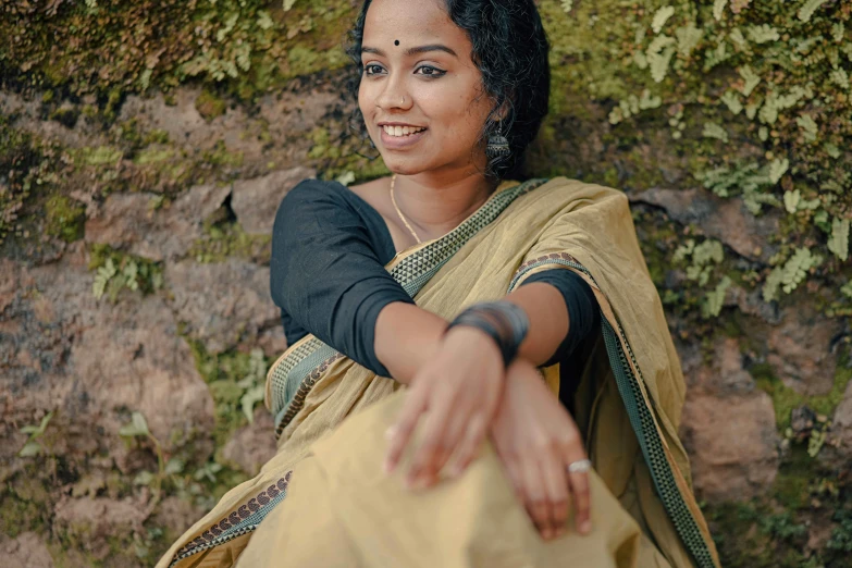 woman in sari smiling and stretching out her arms