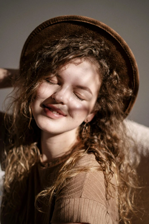 a woman with curly hair is smiling