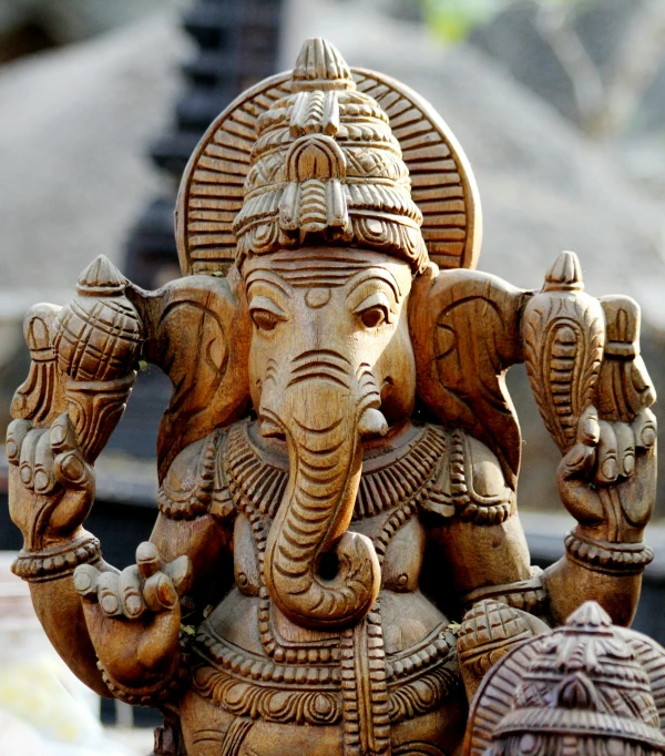 an elephant statue with a temple in the back ground