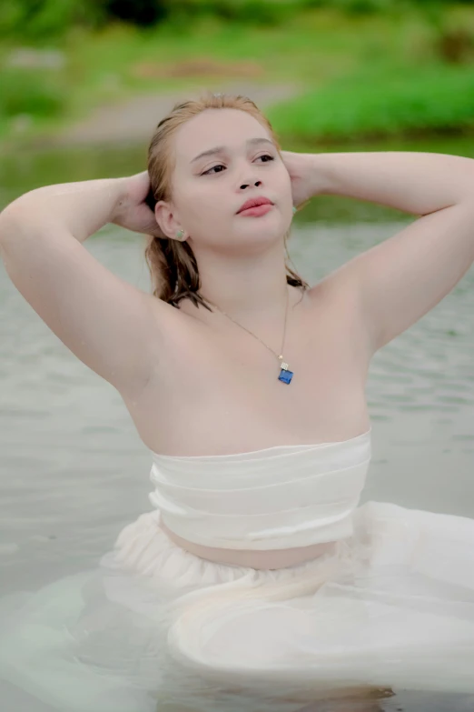 a  with long hair in the water