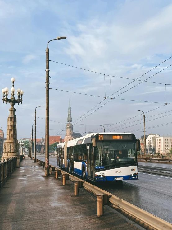 an empty city bus pulls up to the side of the road