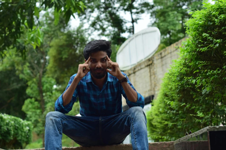 a man is posing with his hands on his head