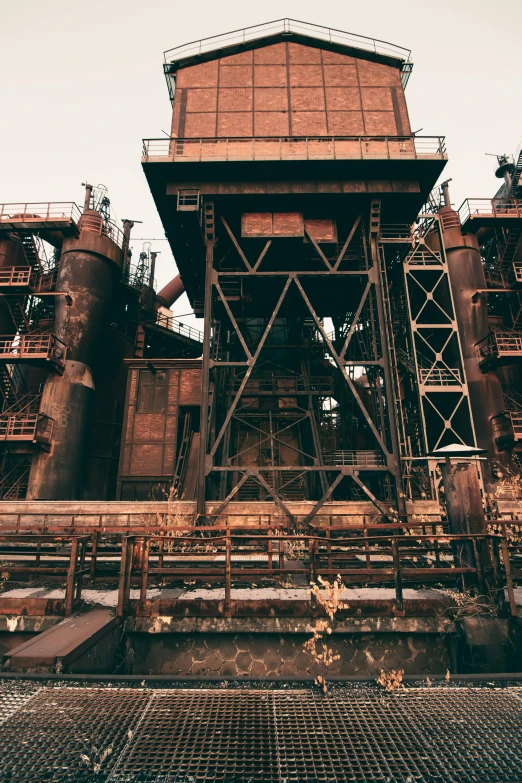 a large tower next to many large industrial pipe stacks