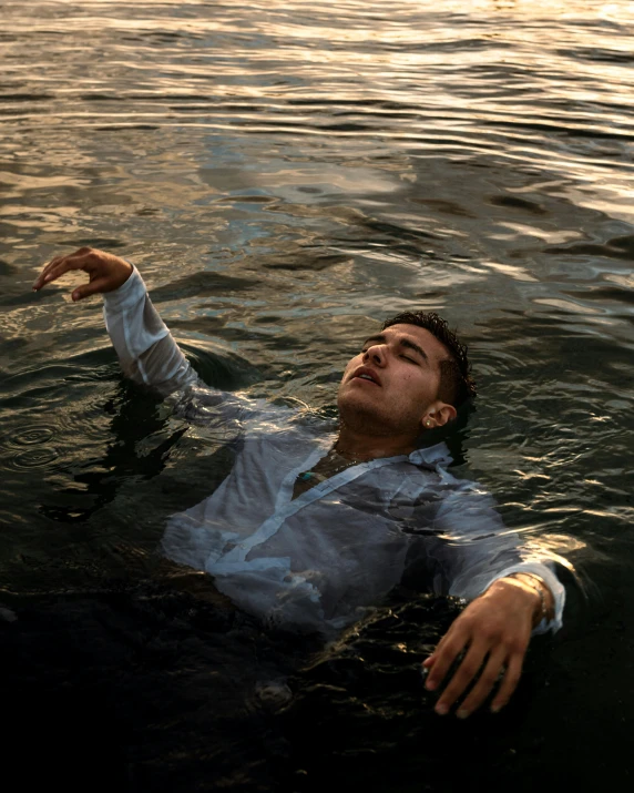 a man is lying down in the water