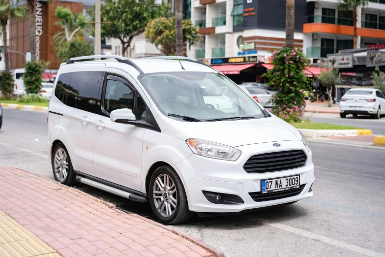 white minivan parked on the side of the road