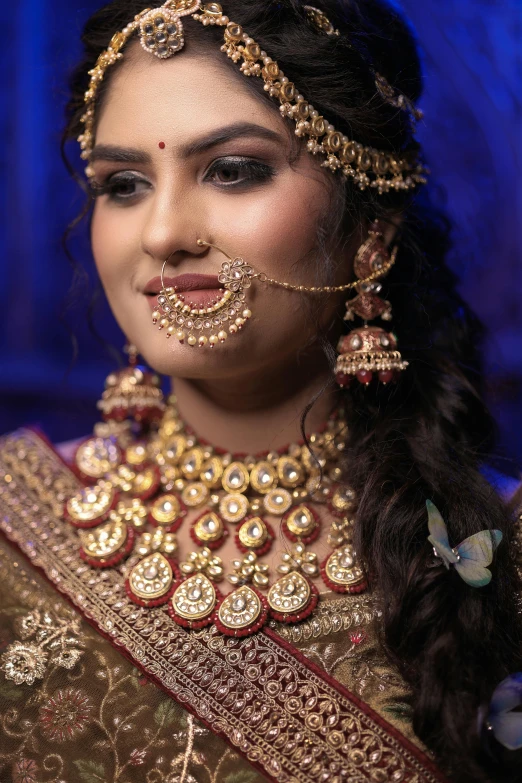 a woman wearing gold jewelry and nose rings