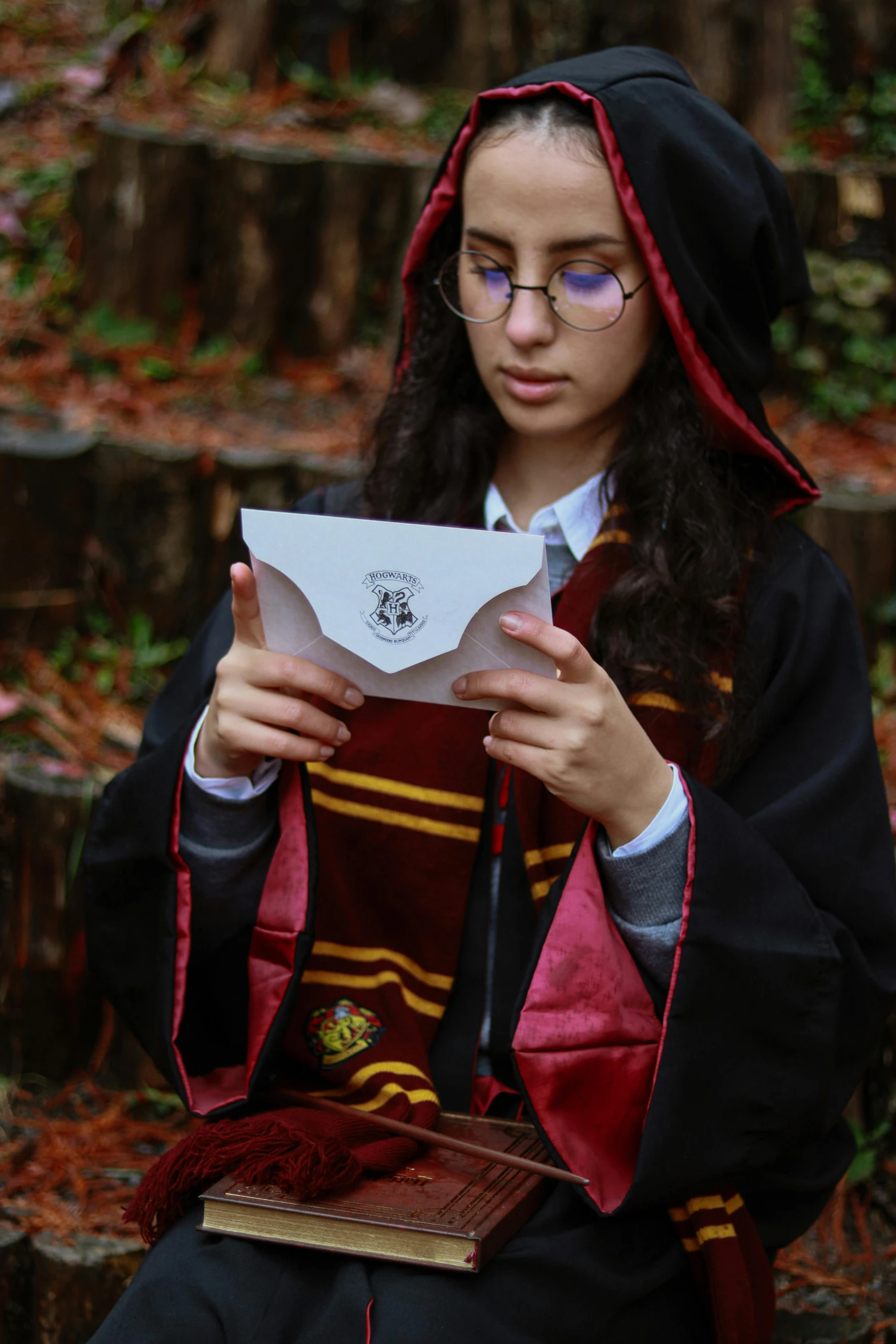 a  in a harry potter robe is reading a paper