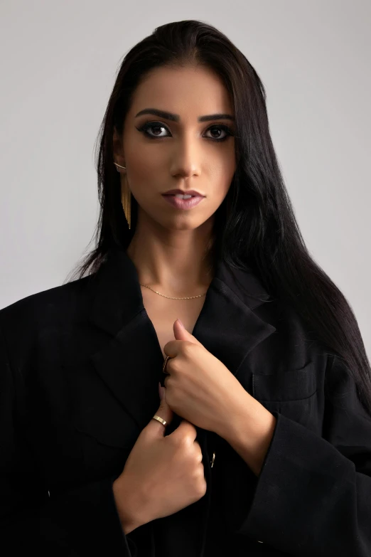 a woman is showing off her necklace and looking at the camera