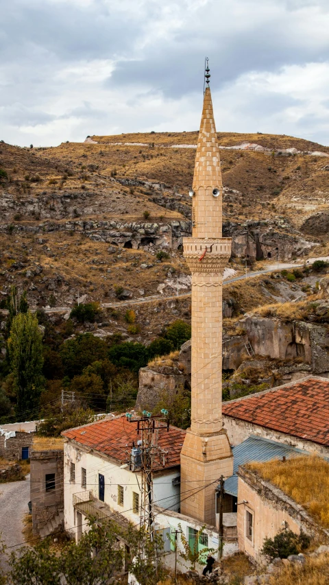 a small clock tower stands tall over other buildings