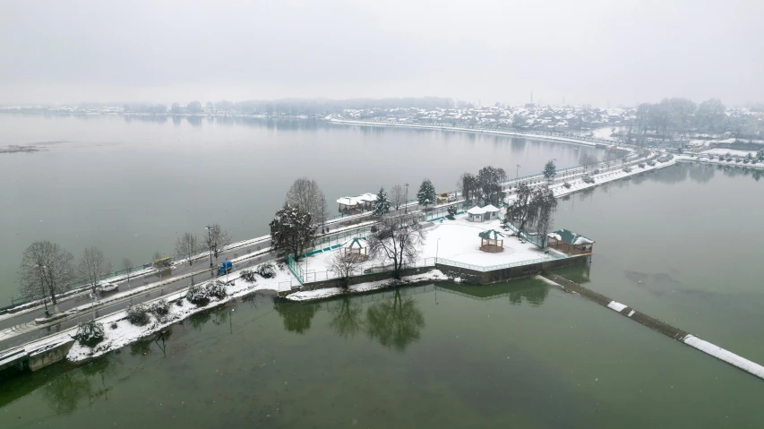 the aerial view of snow - covered houses and water