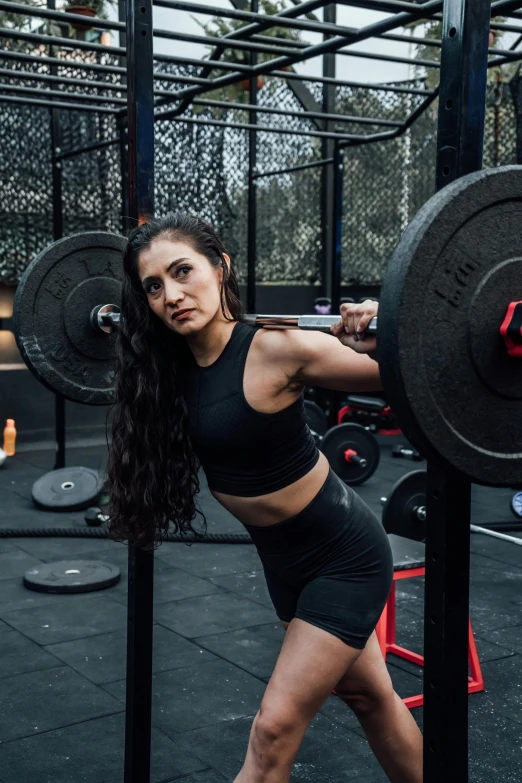 a women that is squatting while doing some type of exercises