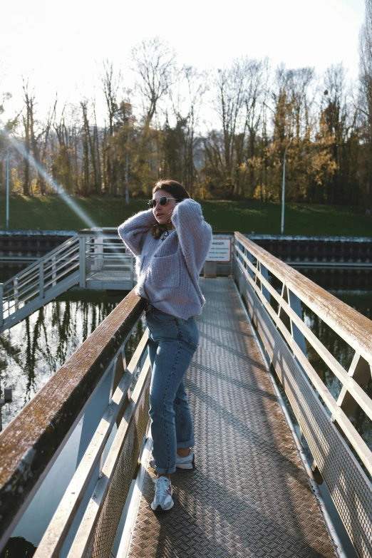 a person standing on a pier, taking a po