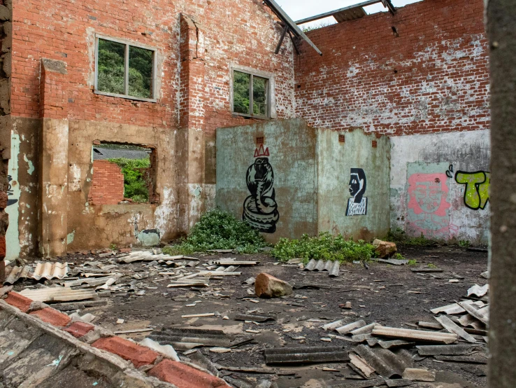 a dilapidated and damaged building has graffiti on the walls