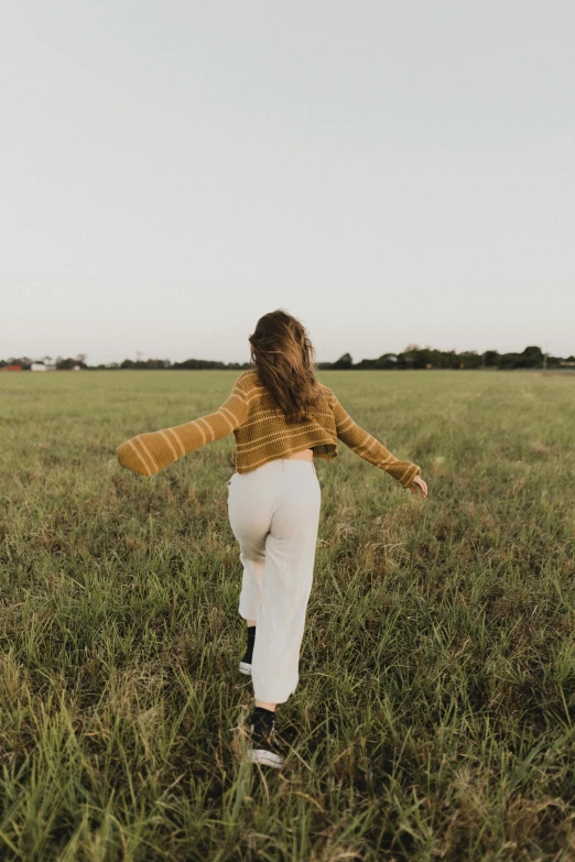 a woman that is in some grass with some legging