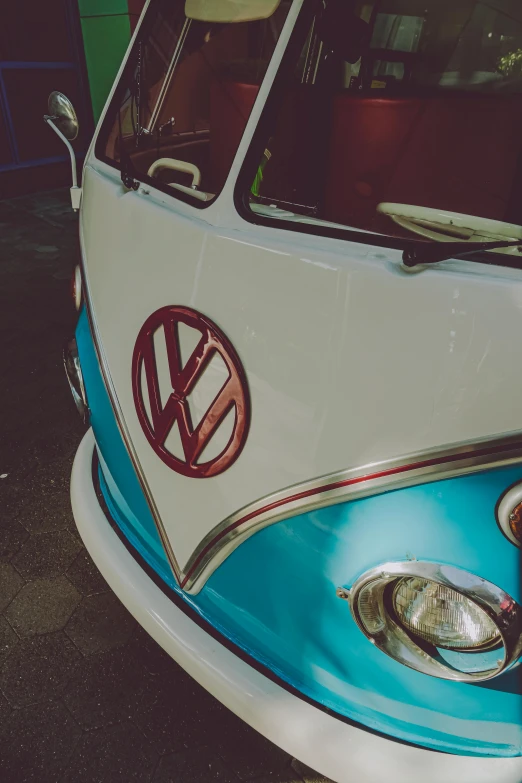 the front of a small blue and white bus