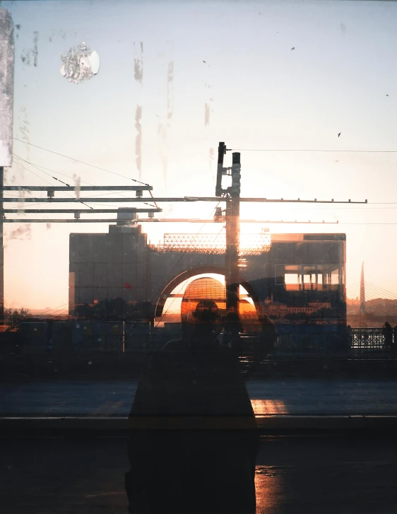 an empty street has a train station with lots of wires hanging overhead