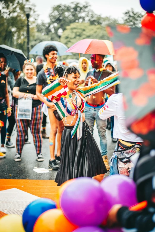 a group of people standing around each other with some colorful umbrellas