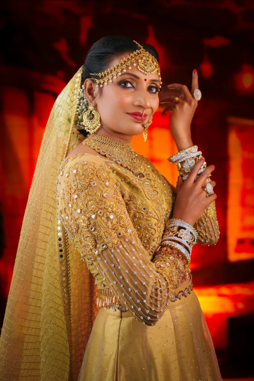 the indian woman in a bridal outfit poses for the camera