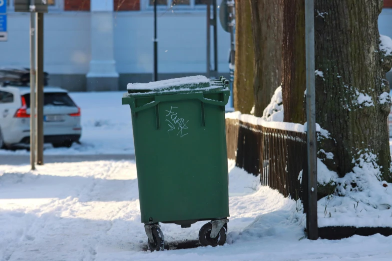 the green trashcan has a message on it