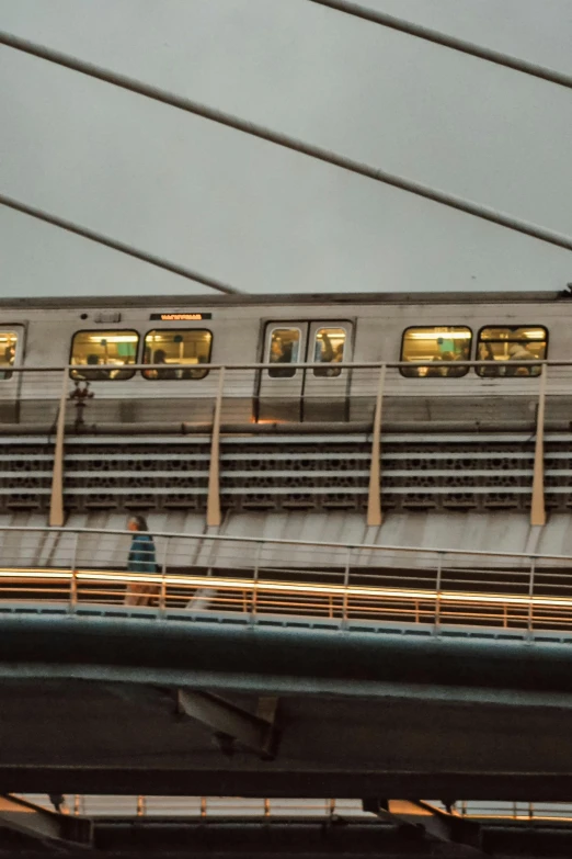 an elevated train passes on the tracks underneath a bridge