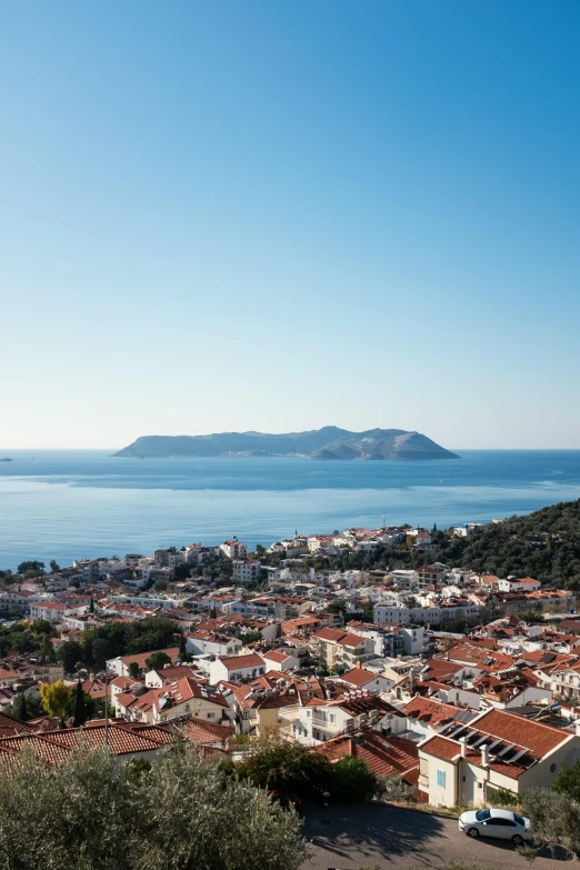 view of a town next to the ocean from a hill