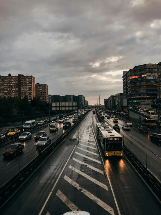 cars and buses are on a rainy highway