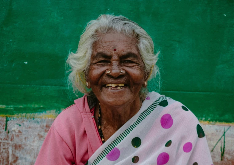 a woman smiles while posing for a picture