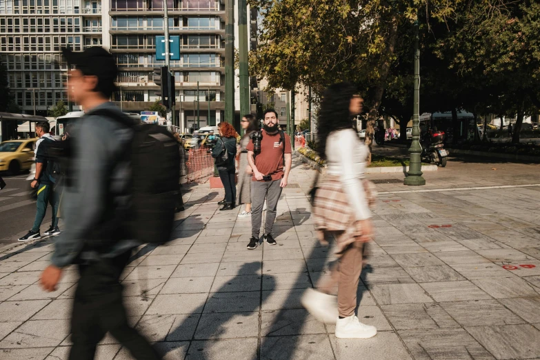 the young men are walking along the street