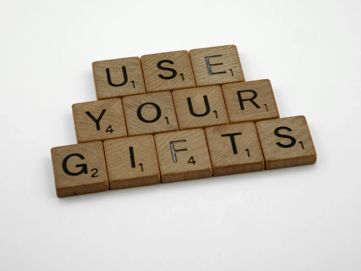 the letters use your gift are spelled by wood blocks