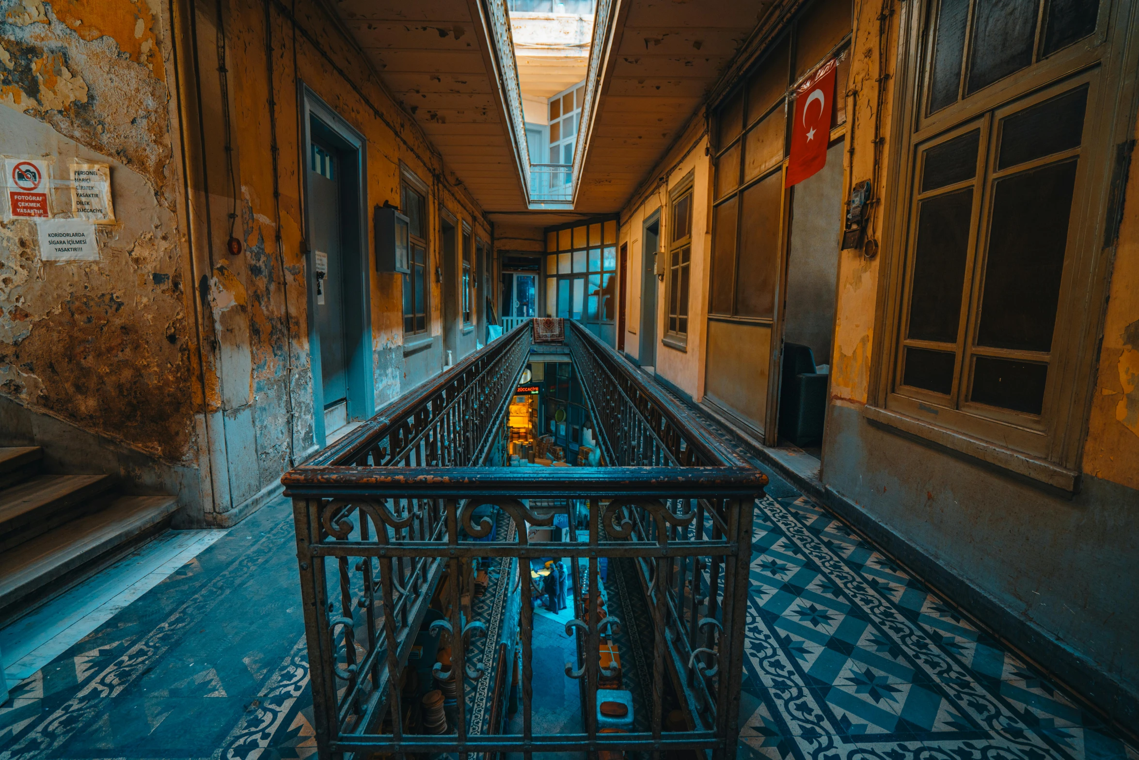 there is a walkway with an iron railing in this building