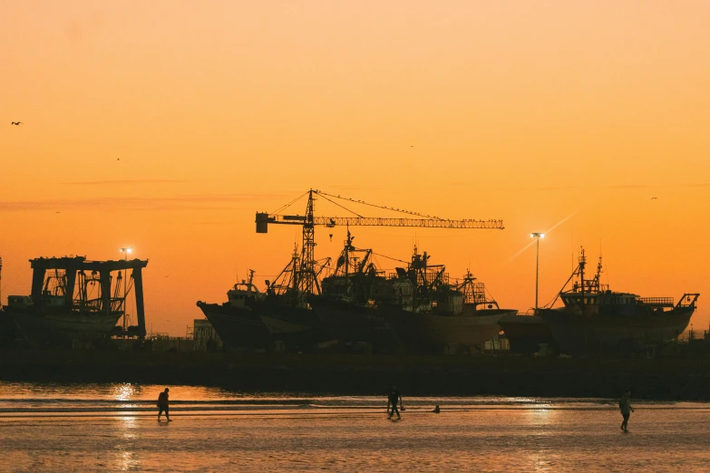 an image of a beautiful sunset with ships docked