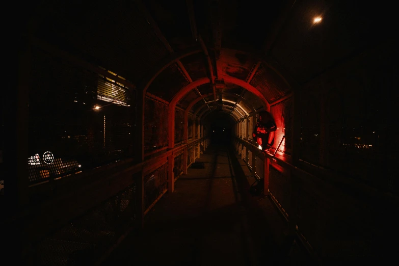 a person walking on the bridge in the dark