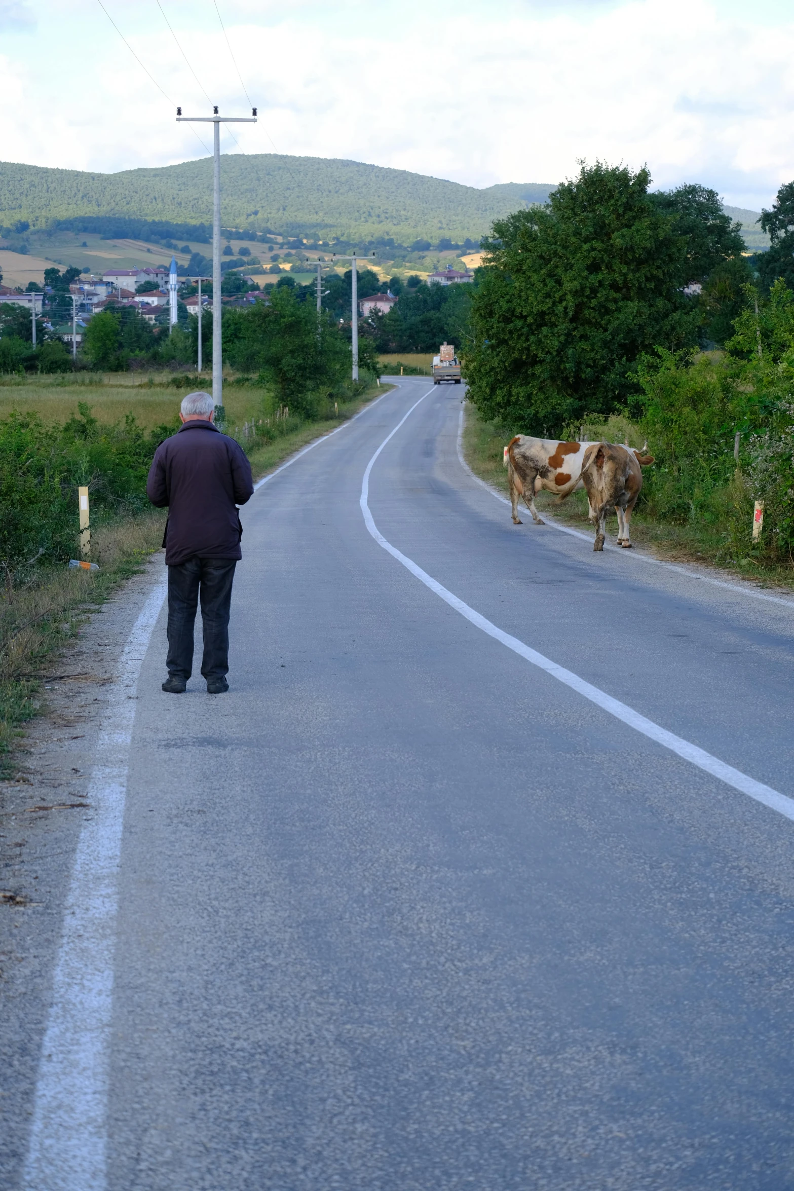 a man that is standing in the middle of a road