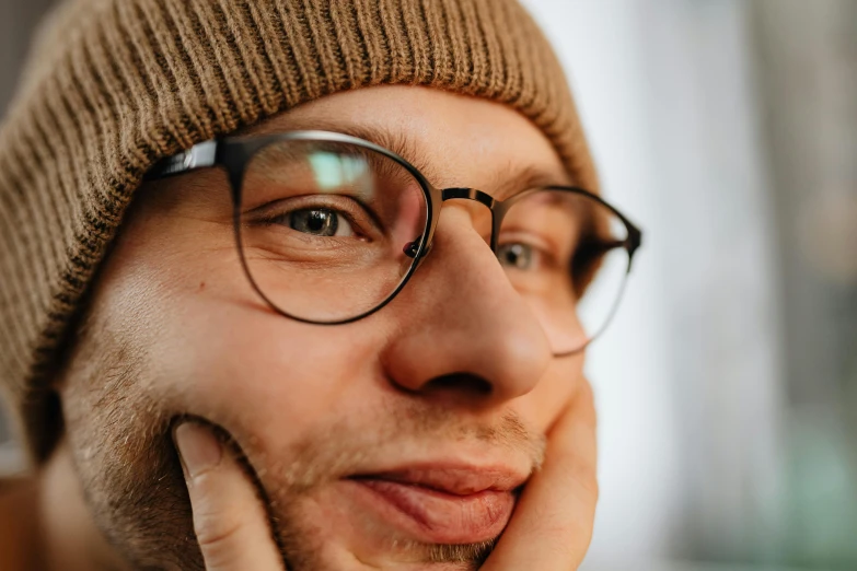 there is a man wearing glasses, with a hat on