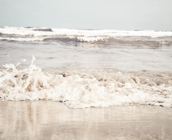 waves roll in towards the beach shore