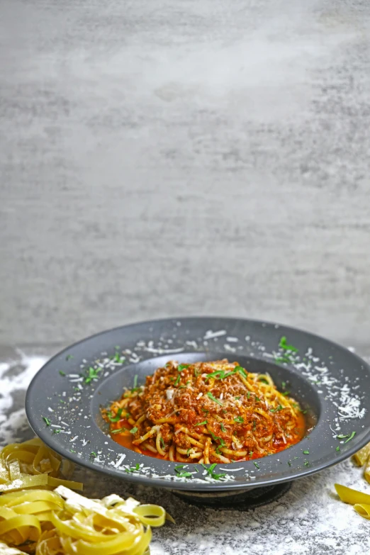 a plate that has noodles on it with parsley and garlic on the side