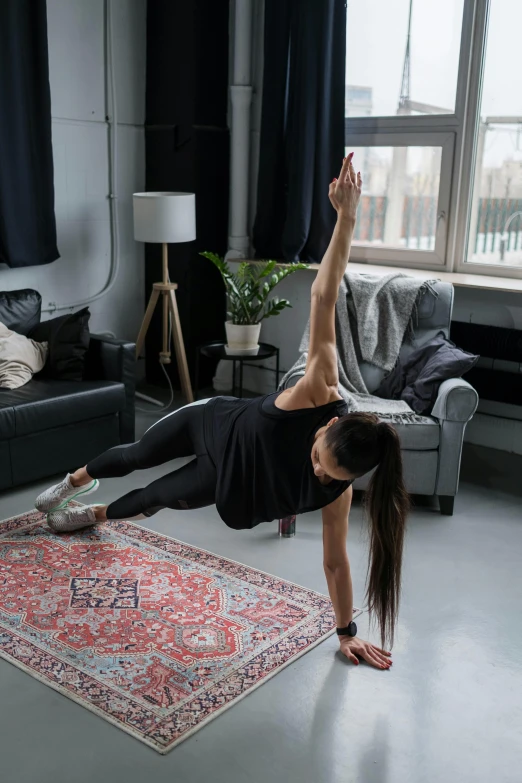 a young lady on a yoga mat practicing a h - up exercise