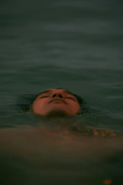 a person floating on top of the water in the middle of the ocean